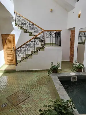 a room with a stairs and a pool of water at Riad in Marrakech