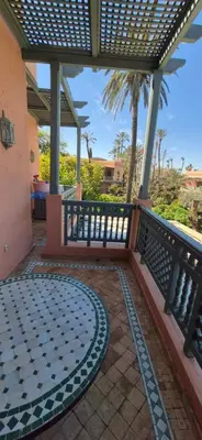 a patio with a lattice fence and a tile floor at Luxe & calme Palmeraie terrasse piscine in Marrakech