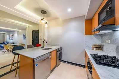 a kitchen with a sink and a stove at Bright & Airy Modern Flat in heart of Marrakech in Marrakech