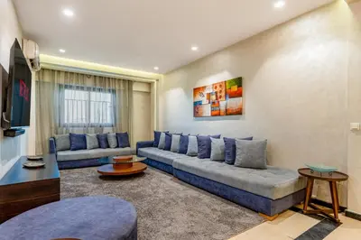 a living room with two couches and a tv at Bright & Airy Modern Flat in heart of Marrakech in Marrakech