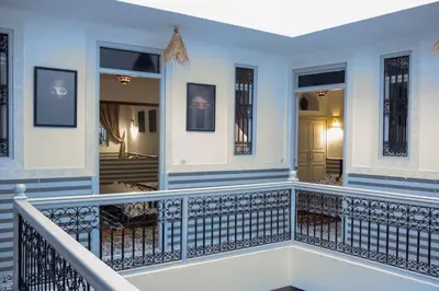 a balcony of a house with a staircase at Riad Allal in Marrakech