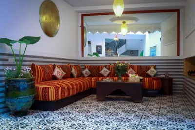 a living room with a couch and a table at Riad Allal in Marrakech