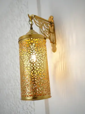 a gold lamp hanging on a wall at Riad privatif Les Tamaris in Marrakech