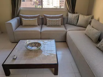 a living room with a couch and a table at Rooftop apartment with large terrace in Guéliz in Marrakech