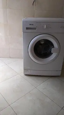 a washing machine is sitting on a tile floor at Rooftop apartment with large terrace in Guéliz in Marrakech