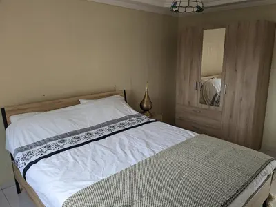 a bedroom with a large bed with a mirror at Rooftop apartment with large terrace in Guéliz in Marrakech
