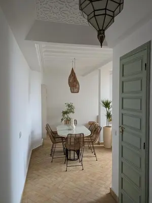 a dining room with a table and chairs at Riad privatif Les Ibéris in Marrakech