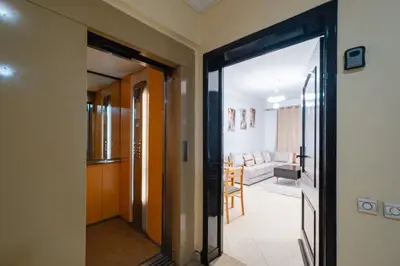 a hallway with a door leading to a living room at Appartement 2 chambres avec terrasse ensoleillée in Marrakech