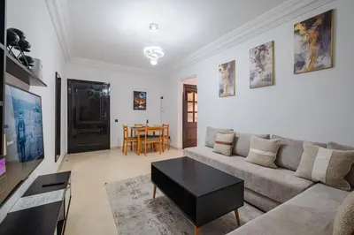 a living room with a couch and a table at Appartement 2 chambres avec terrasse ensoleillée in Marrakech