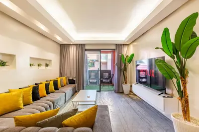 a living room with a large couch and yellow pillows at superbe appartement au coeur de guiliz - victor Hugo in Marrakech