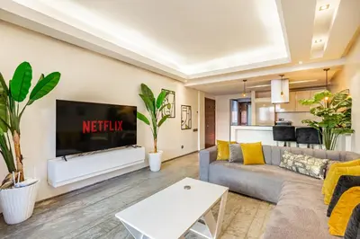 a living room with a couch and a tv at superbe appartement au coeur de guiliz - victor Hugo in Marrakech