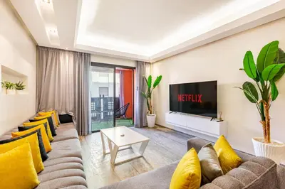 a living room with a couch and a tv at superbe appartement au coeur de guiliz - victor Hugo in Marrakech