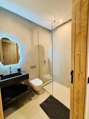 a bathroom with a toilet and a glass shower at Villa MYSK in Marrakech