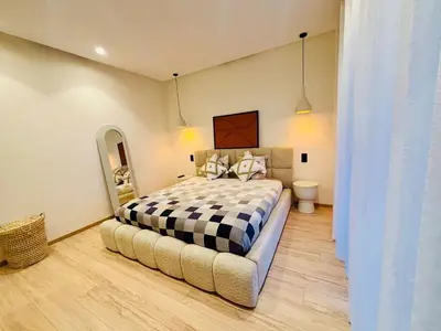 a bedroom with a bed with a black and white checkered blanket at Villa MYSK in Marrakech