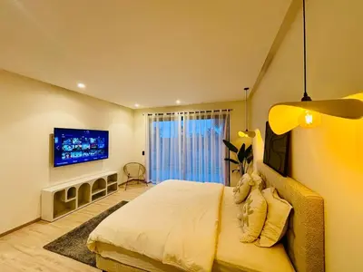 a bedroom with a bed with a teddy bear on it at Villa MYSK in Marrakech