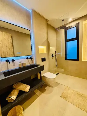 a bathroom with a sink and a toilet and a mirror at Villa MYSK in Marrakech