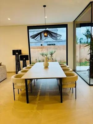a dining room with a table and chairs at Villa MYSK in Marrakech
