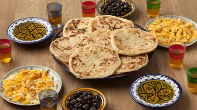 a table with plates of food and bowls of breakfast foods at Riad Blue Marrakech 4 Rooms Jacuzzi Terrace and Pool in Marrakech