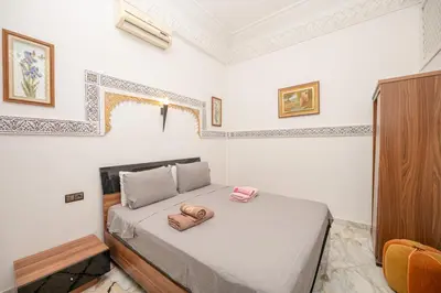 a bedroom with a bed with two towels on it at Riad Blue Marrakech 4 Rooms Jacuzzi Terrace and Pool in Marrakech