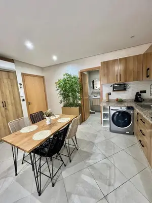 a kitchen and dining room with a table and chairs at New! Apartment F2 Gueliz Station Balcony renovated in Marrakech