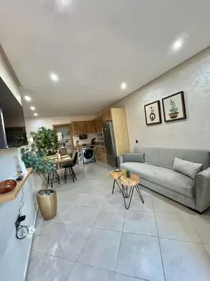 a living room with a couch and a table at New! Apartment F2 Gueliz Station Balcony renovated in Marrakech