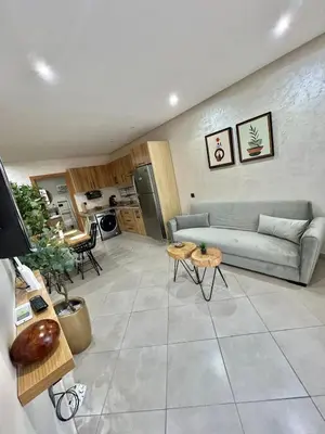 a living room with a couch and a table at New! Apartment F2 Gueliz Station Balcony renovated in Marrakech