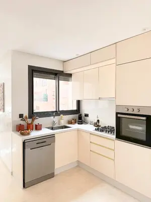 a white kitchen with white cabinets and a window at Appartement Haut Standing 2 Chambres avec 2 Terrasses au Centre Gueliz Marrakech in Marrakech