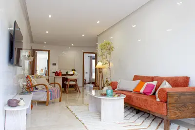 a living room with a couch and a table at Appartement Haut Standing 2 Chambres avec 2 Terrasses au Centre Gueliz Marrakech in Marrakech