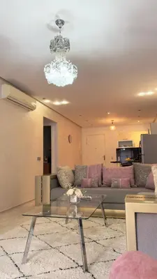 a living room with a couch and a glass table at Apartment gueliz in Marrakech