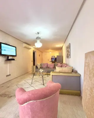 a living room with a couch and a tv at Apartment gueliz in Marrakech