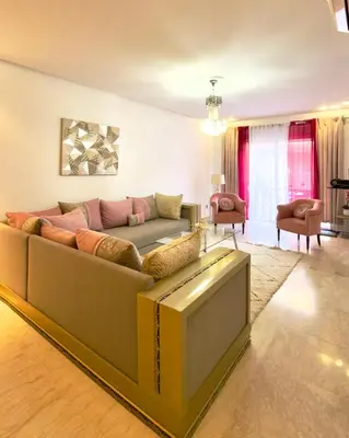 a living room with a couch with a book at Apartment gueliz in Marrakech