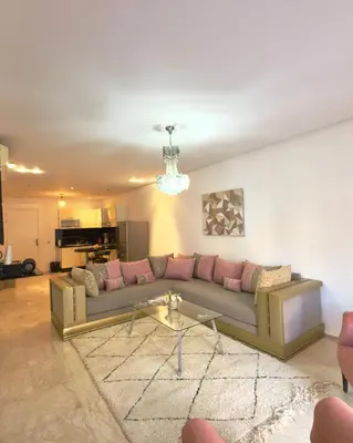 a living room with a couch and a table at Apartment gueliz in Marrakech