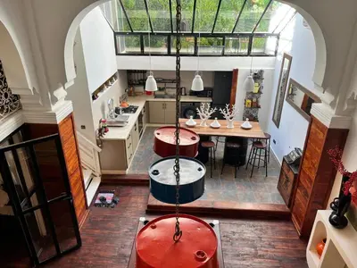 an open kitchen with a table and chairs in it at Loft Harmonia in Marrakech