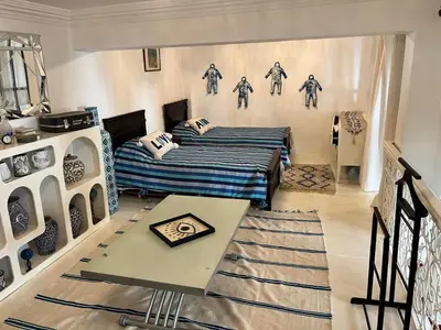 a room with a bed and a table in it at Loft Harmonia in Marrakech