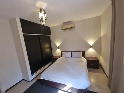 a bedroom with a large white bed with two lights at Villa Victor Hugo in Marrakech