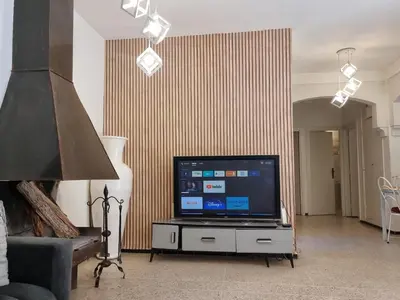 a living room with a television on a table at Villa Victor Hugo in Marrakech