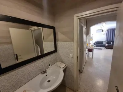 a bathroom with a sink and a mirror at Villa Victor Hugo in Marrakech