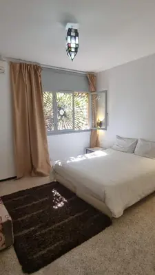 a bedroom with a large bed and a window at Villa Victor Hugo in Marrakech