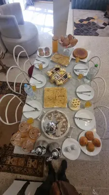 a table topped with plates of food and pastries at Villa Victor Hugo in Marrakech