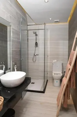 a bathroom with a shower and a sink and a toilet at Éminence Living in Marrakech