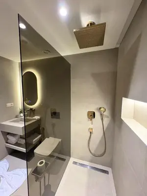 a bathroom with a shower and a toilet and a sink at Plaza Marrakech Comfort Stay in Marrakech
