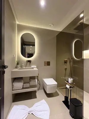 a bathroom with a sink and a toilet and a mirror at Plaza Marrakech Comfort Stay in Marrakech