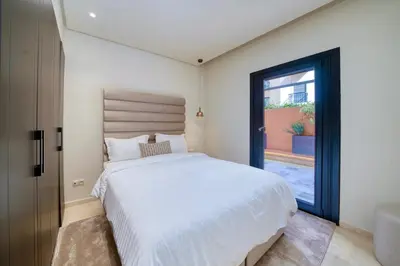 a bedroom with a white bed and a window at Plaza Marrakech Comfort Stay in Marrakech