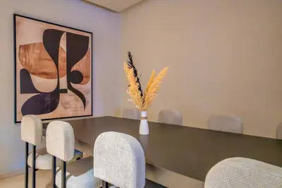 a dining room with a table and chairs at Plaza Marrakech Comfort Stay in Marrakech