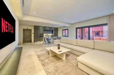 a living room with a couch and a table at Plaza Marrakech Comfort Stay in Marrakech