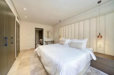 a bedroom with a large white bed and a desk at Plaza Marrakech Comfort Stay in Marrakech