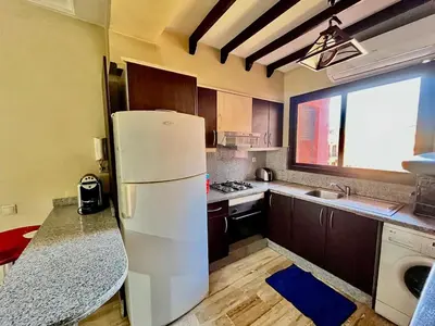 a kitchen with a white refrigerator and a window at City zen gueliz 1BR apartment in Marrakech