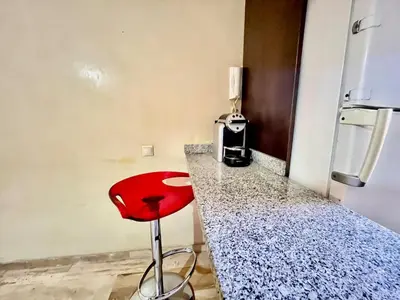 a red stool sitting on a counter in a kitchen at City zen gueliz 1BR apartment in Marrakech