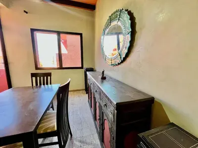 a dining room with a table and a mirror on the wall at City zen gueliz 1BR apartment in Marrakech