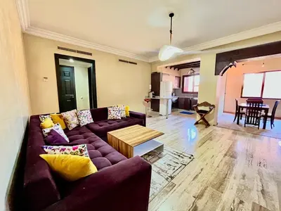 a living room with a purple couch and a table at City zen gueliz 1BR apartment in Marrakech